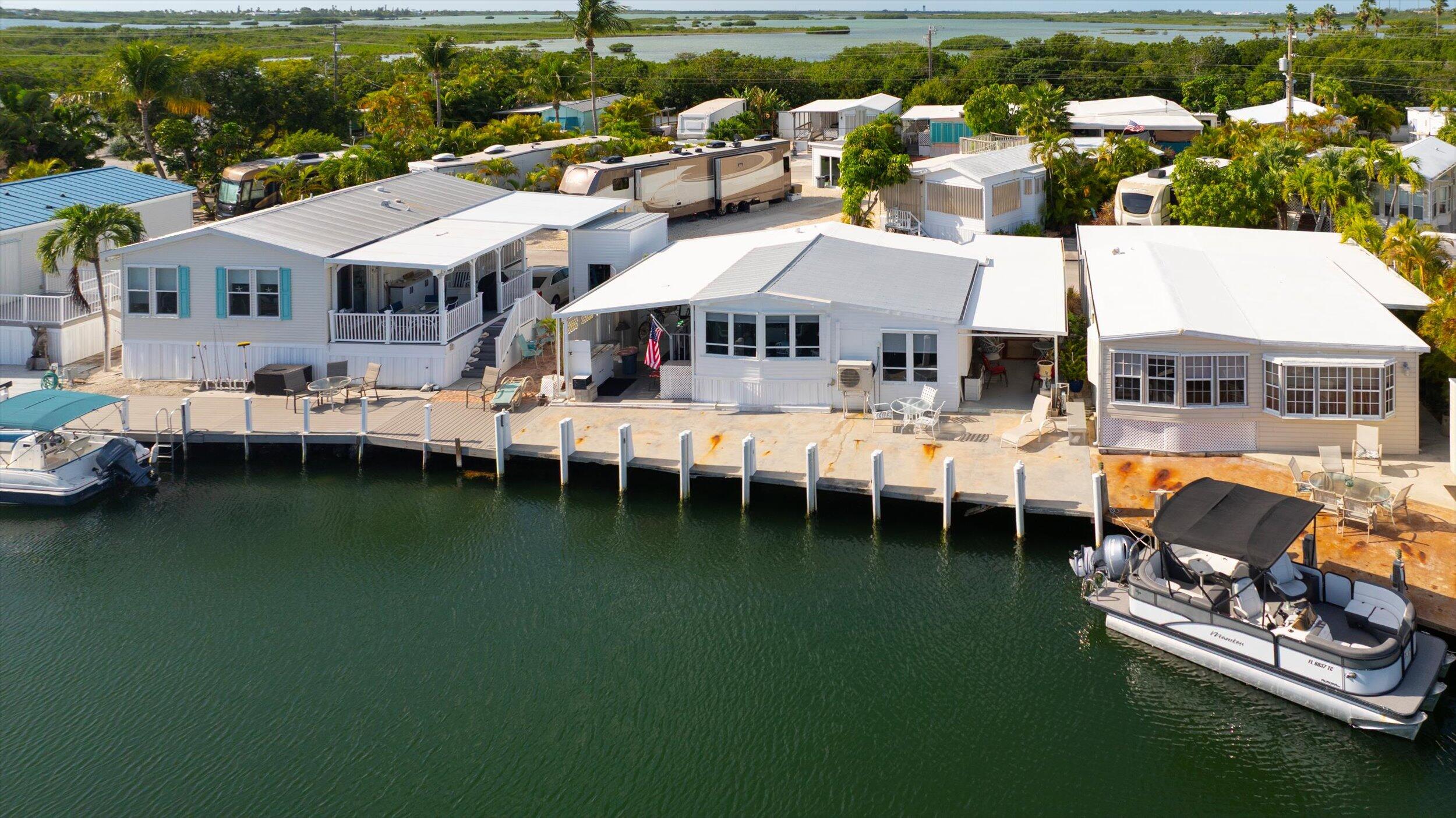 55 Boca Chica Road, Unit 132 Key West, FL 33040 - Photo 49 of 52 a aerial view of a house with swimming pool and outdoor seating