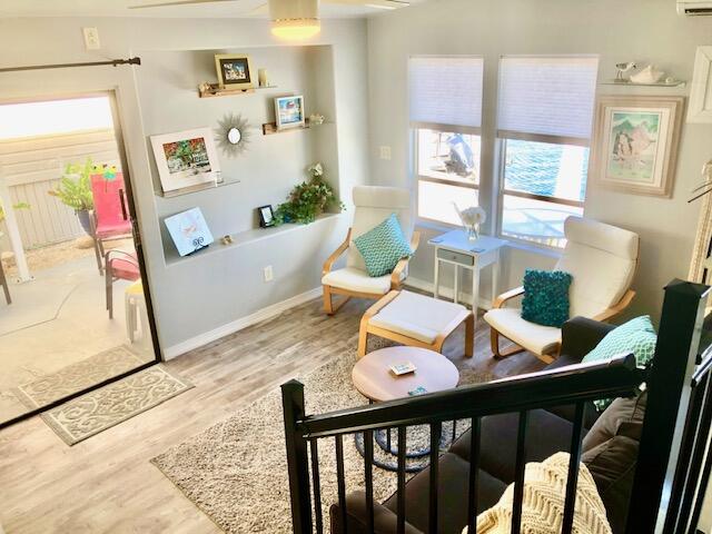 55 Boca Chica Road, Unit 132 Key West, FL 33040 - Photo 5 of 54 a living room with furniture and wooden floor