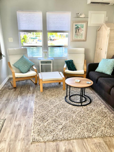 55 Boca Chica Road, Unit 132 Key West, FL 33040 - Photo 6 of 54 a living room with furniture a rug and a large window