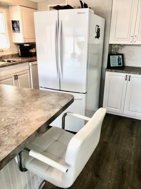 55 Boca Chica Road, Unit 132 Key West, FL 33040 - Photo 8 of 54 a kitchen with stainless steel appliances cabinets and wooden floor