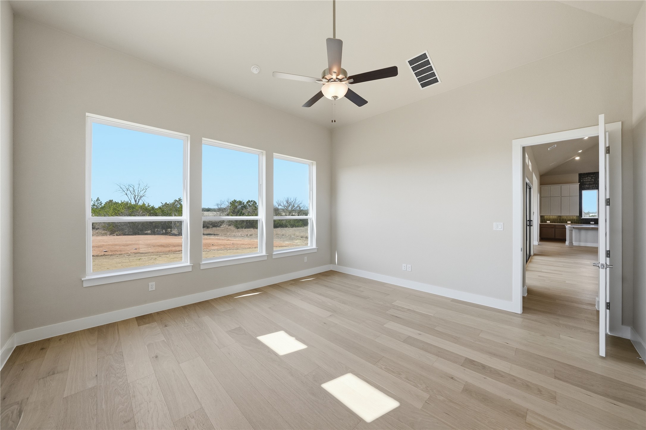 1209 Doelling Drive Georgetown, TX 78633 - Photo 11 of 31 Unfurnished room with a ceiling fan and light wood-style floors