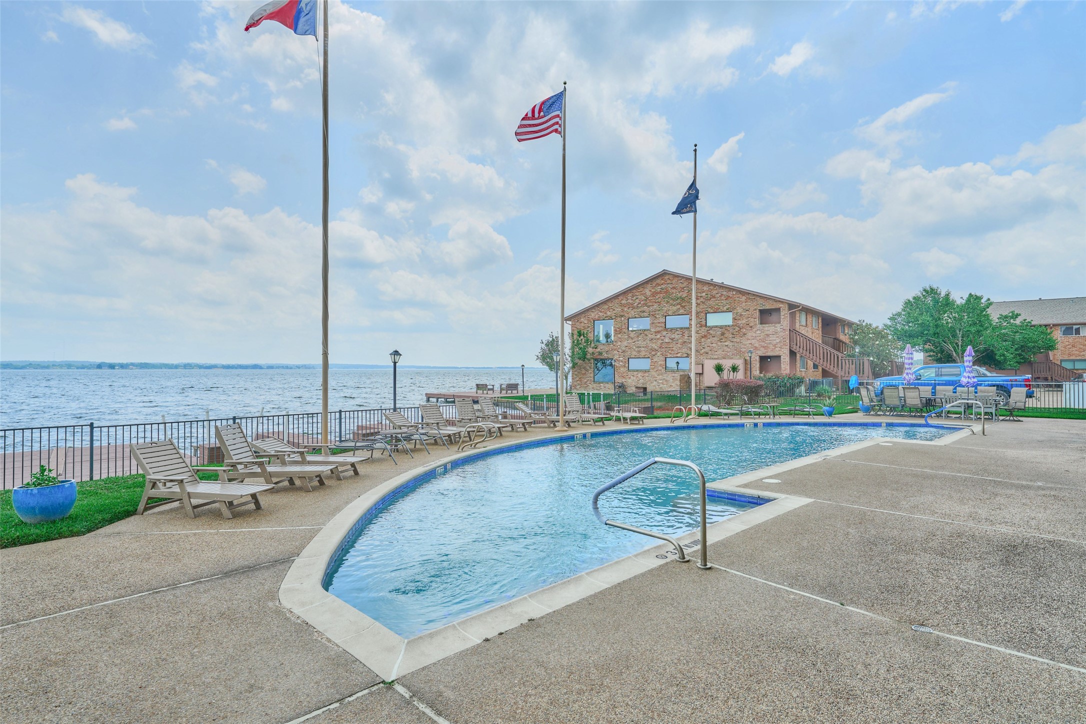 801 River Road, Unit 105D Montgomery, TX 77356 - Photo 29 of 32 a swimming pool with lawn chairs next to yard