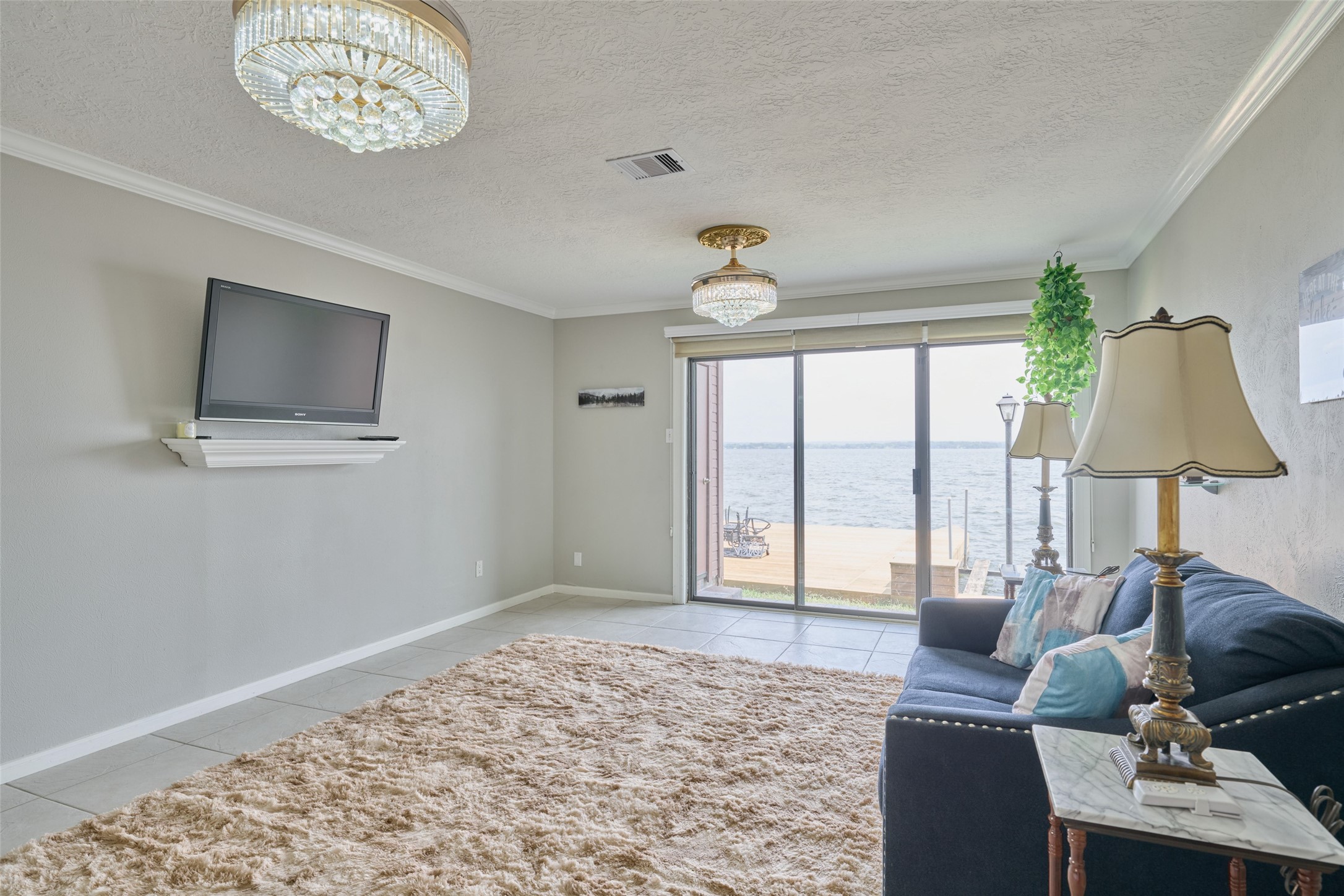 801 River Road, Unit 105D Montgomery, TX 77356 - Photo 5 of 32 a living room with furniture and a flat screen tv