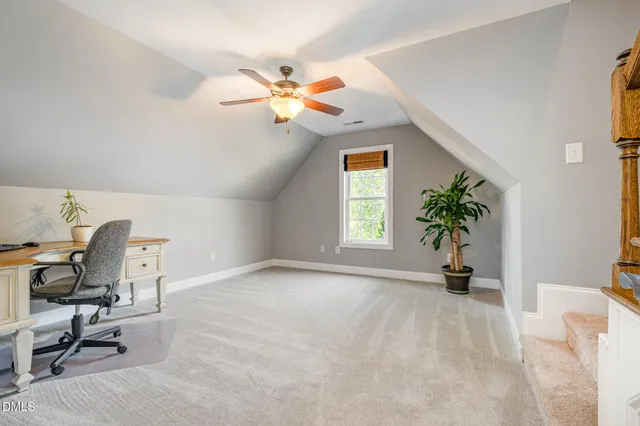 a view of workspace with a window and chair