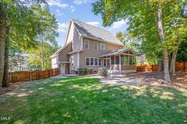 a view of a house with a yard and sitting area