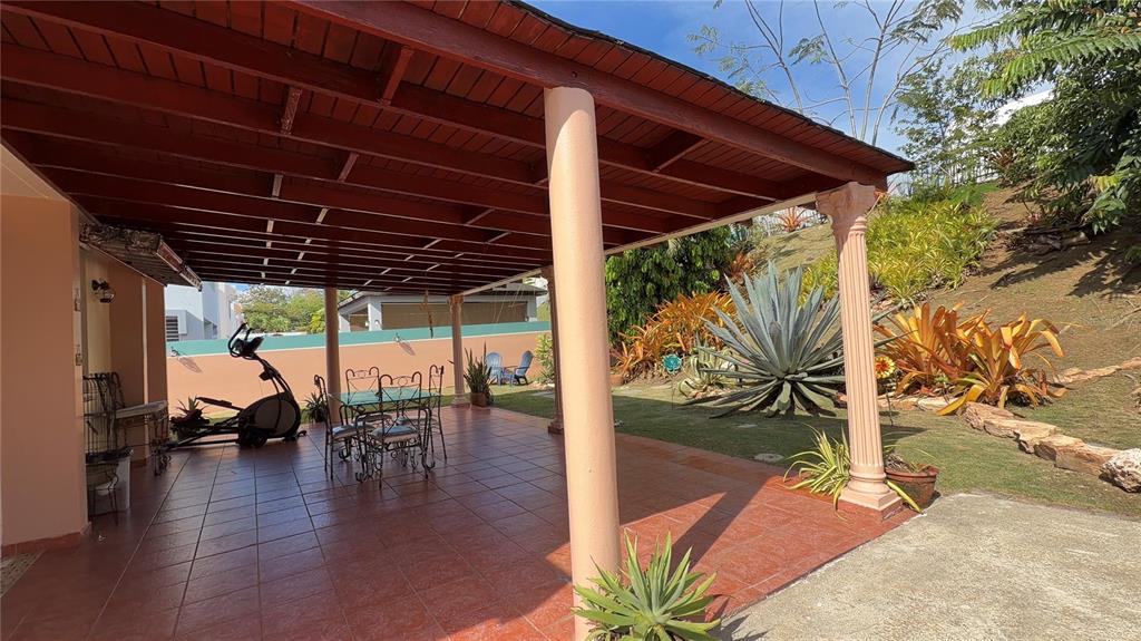 1 St Rio Grande, Unit B6 Rio Grande, PR 00745 - Photo 18 of 47 a view of a porch with a table and chairs under an umbrella