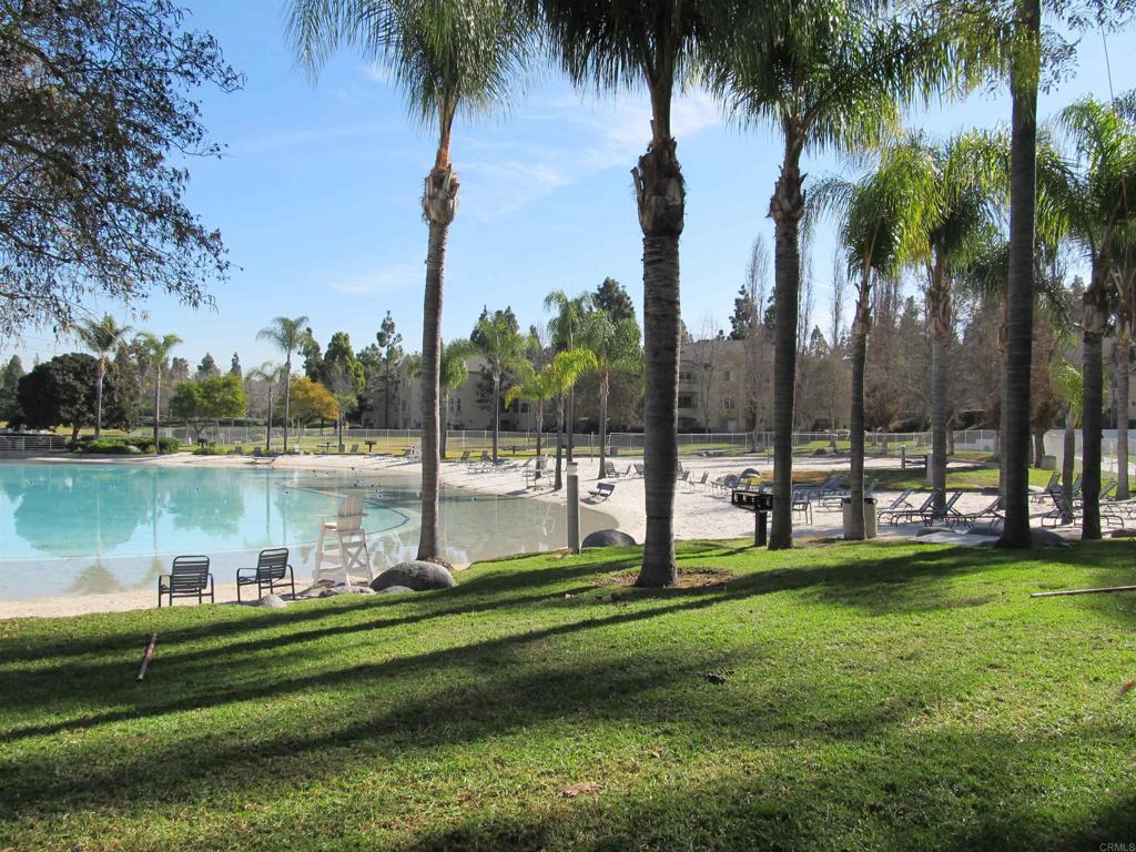 2023 Lakeridge Circle, Unit 203 Chula Vista, CA 91913 - Photo 23 of 24 a view of a swimming pool with a garden and lake view