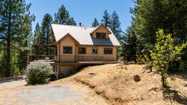 a view of a yard with trees in front of it
