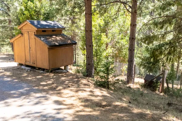 a view of a balcony with wooden floor and iron fence