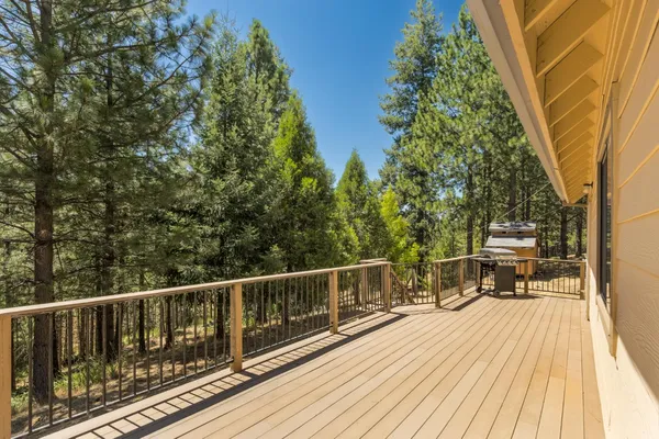 a view of a house with a bed and wooden fence
