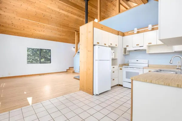 a kitchen with a refrigerator a stove top oven a sink and dishwasher