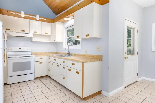 a kitchen with cabinets appliances and a sink