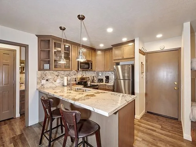 a view of a room with furniture and wooden floor