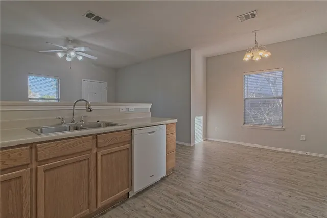 a kitchen with granite countertop cabinets and white appliances