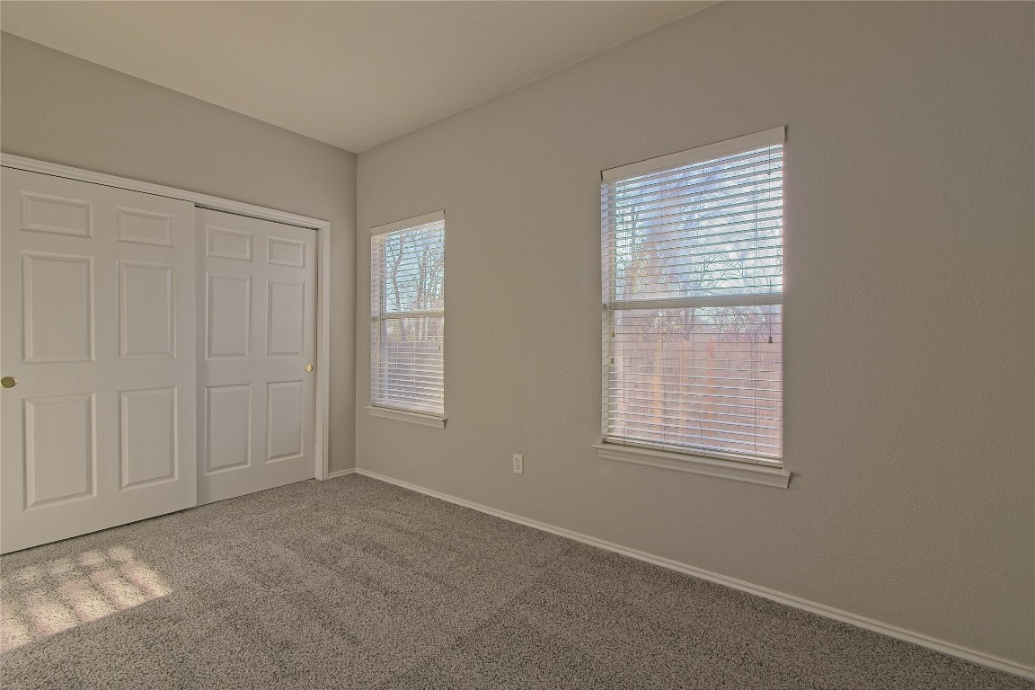 1102 East 3rd Street Georgetown, TX 78626 - Photo 16 of 36 Unfurnished bedroom featuring carpet flooring and a closet