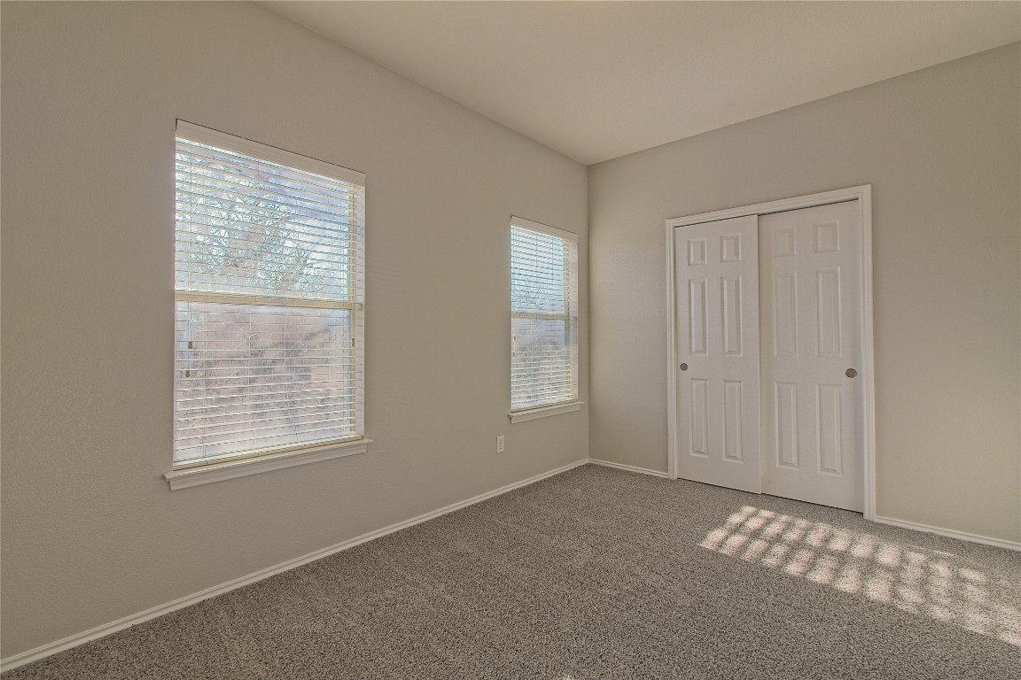 1102 East 3rd Street Georgetown, TX 78626 - Photo 23 of 36 Unfurnished bedroom featuring carpet floors and a closet