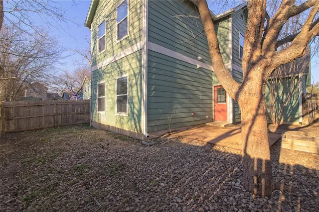 a bathroom with a granite countertop sink a toilet and a large mirror