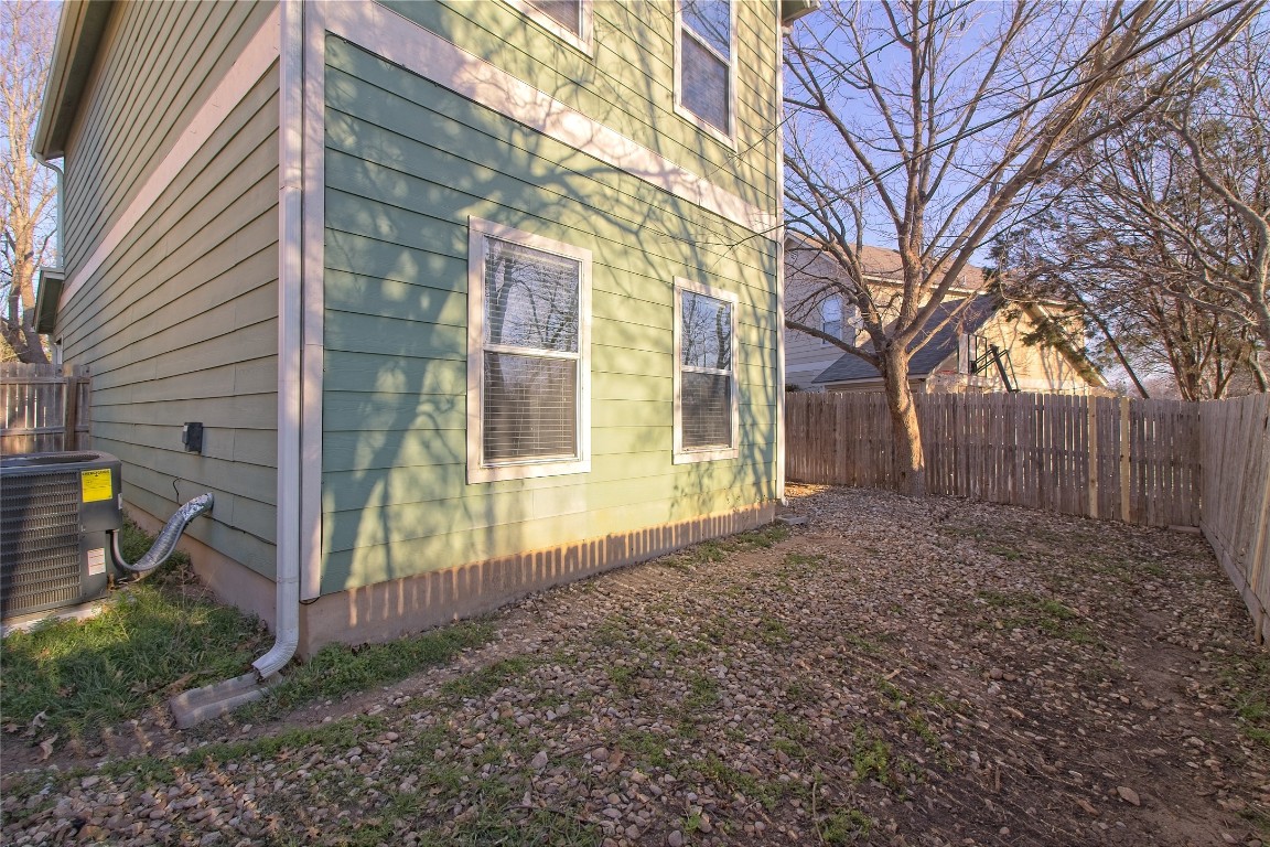1102 East 3rd Street Georgetown, TX 78626 - Photo 29 of 36 View of side of home featuring a fenced backyard
