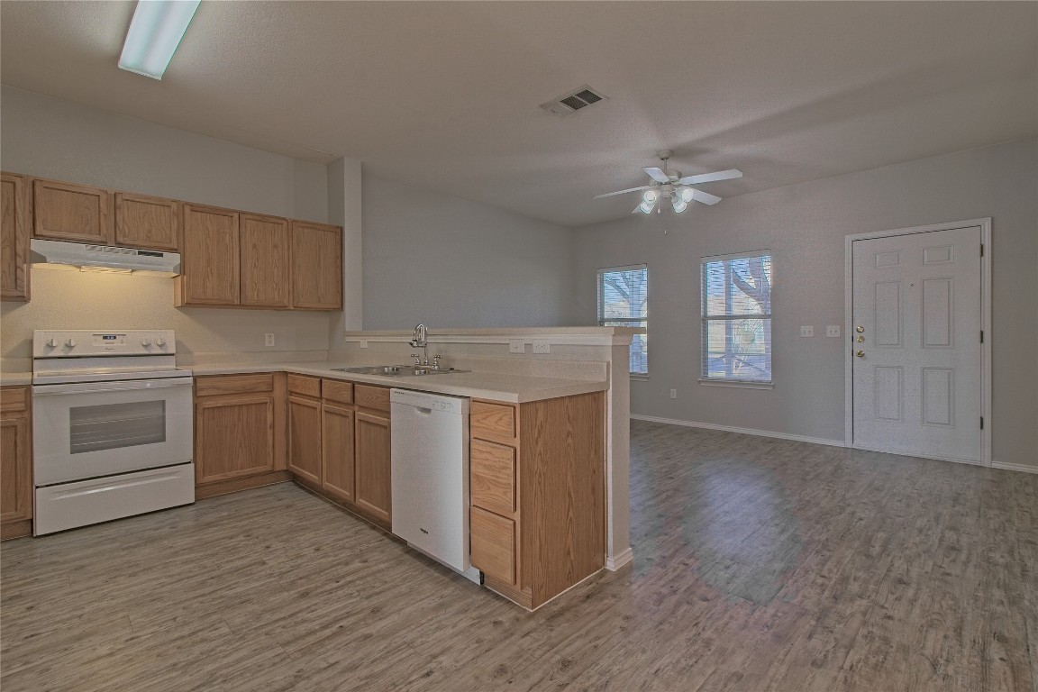 1102 East 3rd Street Georgetown, TX 78626 - Photo 36 of 36 Kitchen featuring white appliances, light countertops, open floor plan, under cabinet range hood, and a ceiling fan