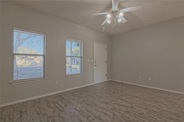 an empty room with a empty space and a ceiling fan