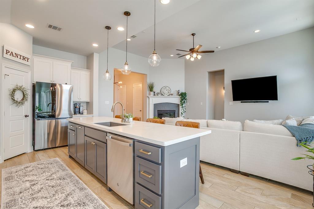 2453 Lazy Dog Lane Northlake, TX 76247 - Photo 39 of 40 Kitchen with gray cabinets, stainless steel appliances, decorative light fixtures, open floor plan, and white cabinetry