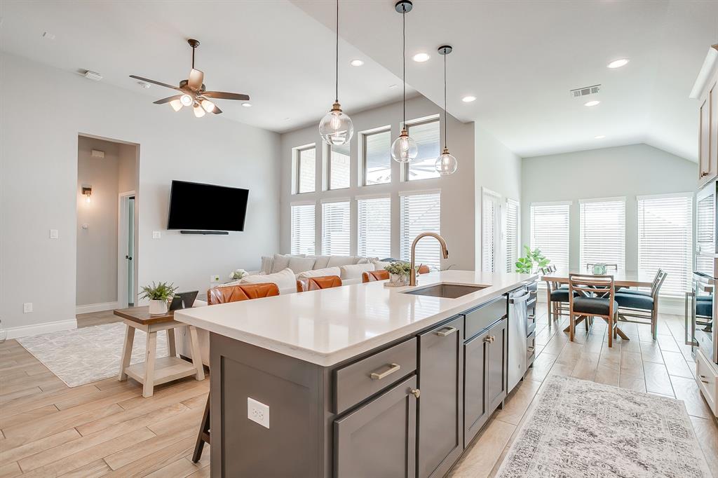 2453 Lazy Dog Lane Northlake, TX 76247 - Photo 40 of 40 Kitchen with a breakfast bar, hanging light fixtures, an island with sink, light wood-style flooring, and open floor plan