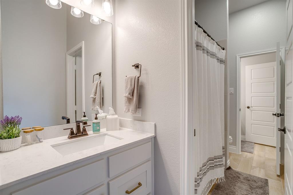2453 Lazy Dog Lane Northlake, TX 76247 - Photo 15 of 40 Full bath featuring vanity, a textured wall, and a shower with curtain