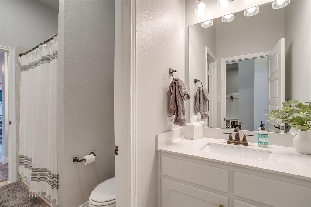 2453 Lazy Dog Lane Northlake, TX 76247 - Photo 16 of 40 Bathroom featuring vanity, a textured wall, and a shower with curtain