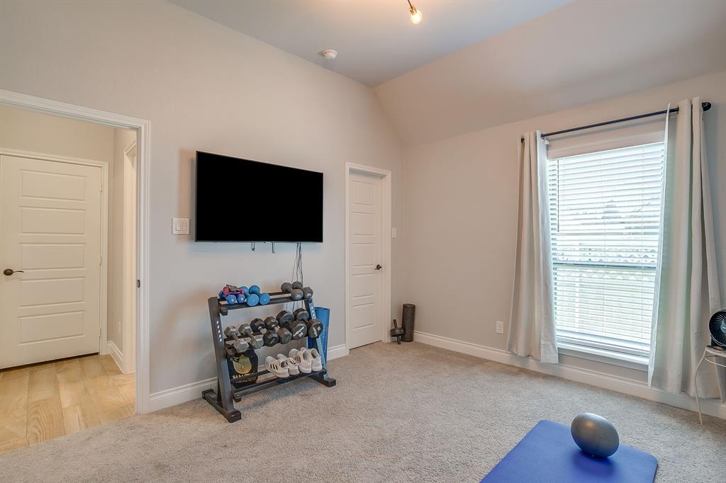 2453 Lazy Dog Lane Northlake, TX 76247 - Photo 17 of 40 Workout room with vaulted ceiling and light colored carpet