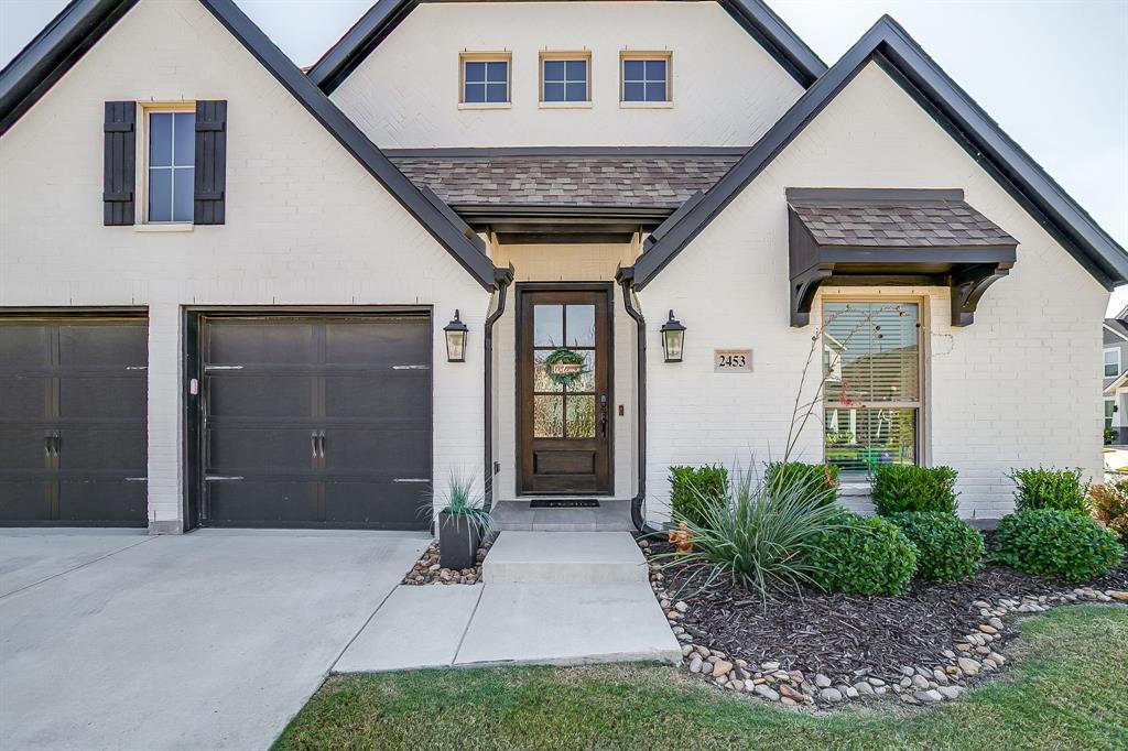2453 Lazy Dog Lane Northlake, TX 76247 - Photo 2 of 40 View of front facade featuring a shingled roof, brick siding, a garage, and concrete driveway