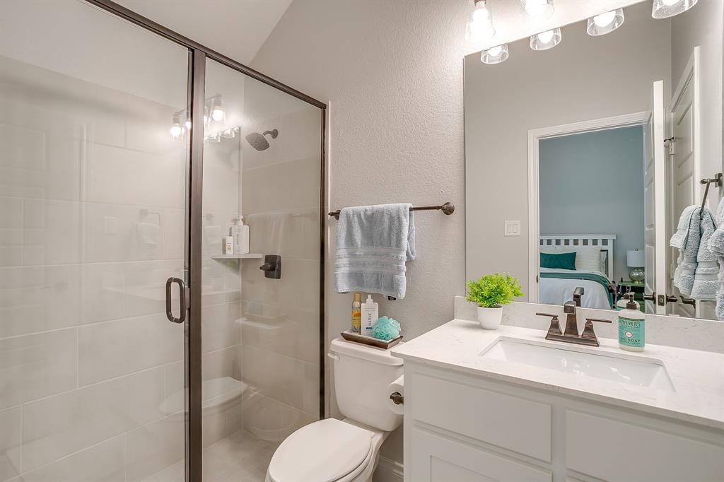 2453 Lazy Dog Lane Northlake, TX 76247 - Photo 19 of 40 Ensuite bathroom featuring a textured wall, a shower stall, and vanity