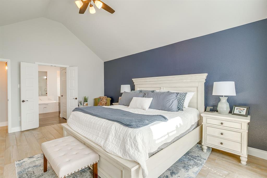 2453 Lazy Dog Lane Northlake, TX 76247 - Photo 22 of 40 Bedroom with light wood-style floors, ensuite bath, a ceiling fan, and high vaulted ceiling