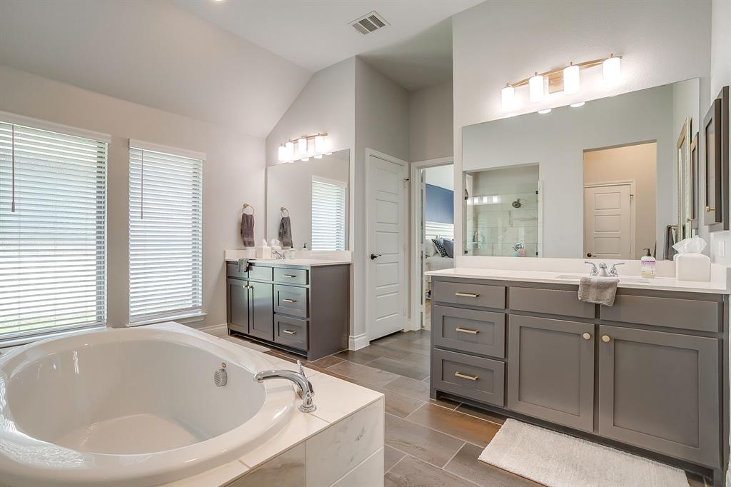 2453 Lazy Dog Lane Northlake, TX 76247 - Photo 25 of 40 Full bath featuring a stall shower, two vanities, a bath, and lofted ceiling