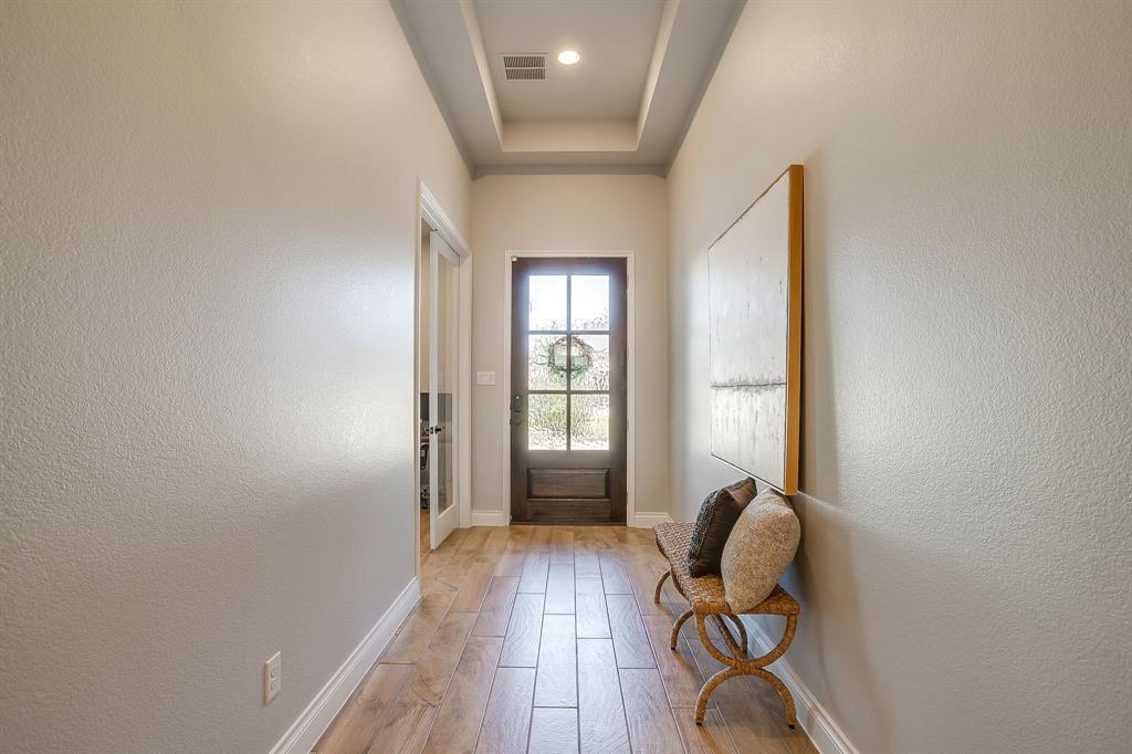 2453 Lazy Dog Lane Northlake, TX 76247 - Photo 3 of 40 Entryway with wood finished floors, a textured wall, and a tray ceiling