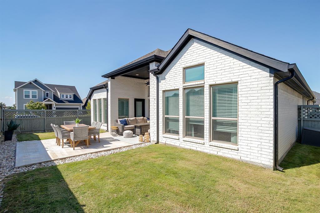 2453 Lazy Dog Lane Northlake, TX 76247 - Photo 30 of 40 Back of property featuring a fenced backyard, a patio area, a ceiling fan, outdoor lounge area, and brick siding