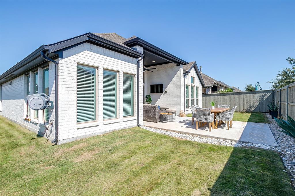 2453 Lazy Dog Lane Northlake, TX 76247 - Photo 31 of 40 Back of property with ceiling fan, a patio area, a fenced backyard, outdoor lounge area, and brick siding