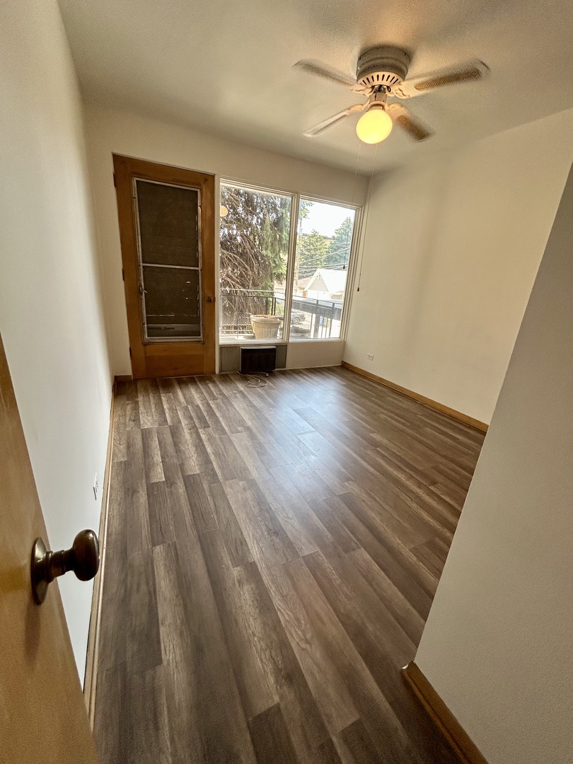 7446 Franklin Street, Unit 1NE Forest Park, IL 60130 - Photo 3 of 7 wooden floor in an empty room with a window