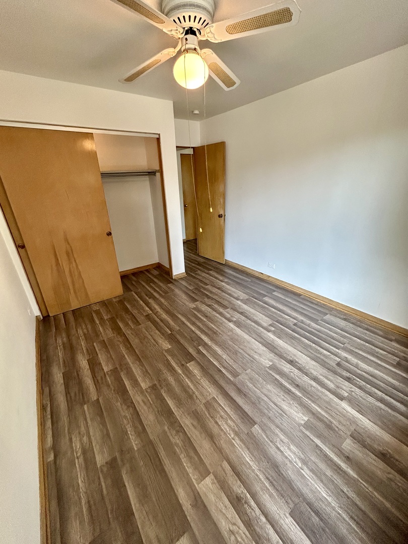 7446 Franklin Street, Unit 1NE Forest Park, IL 60130 - Photo 5 of 7 a view of an empty room with wooden floor and a window