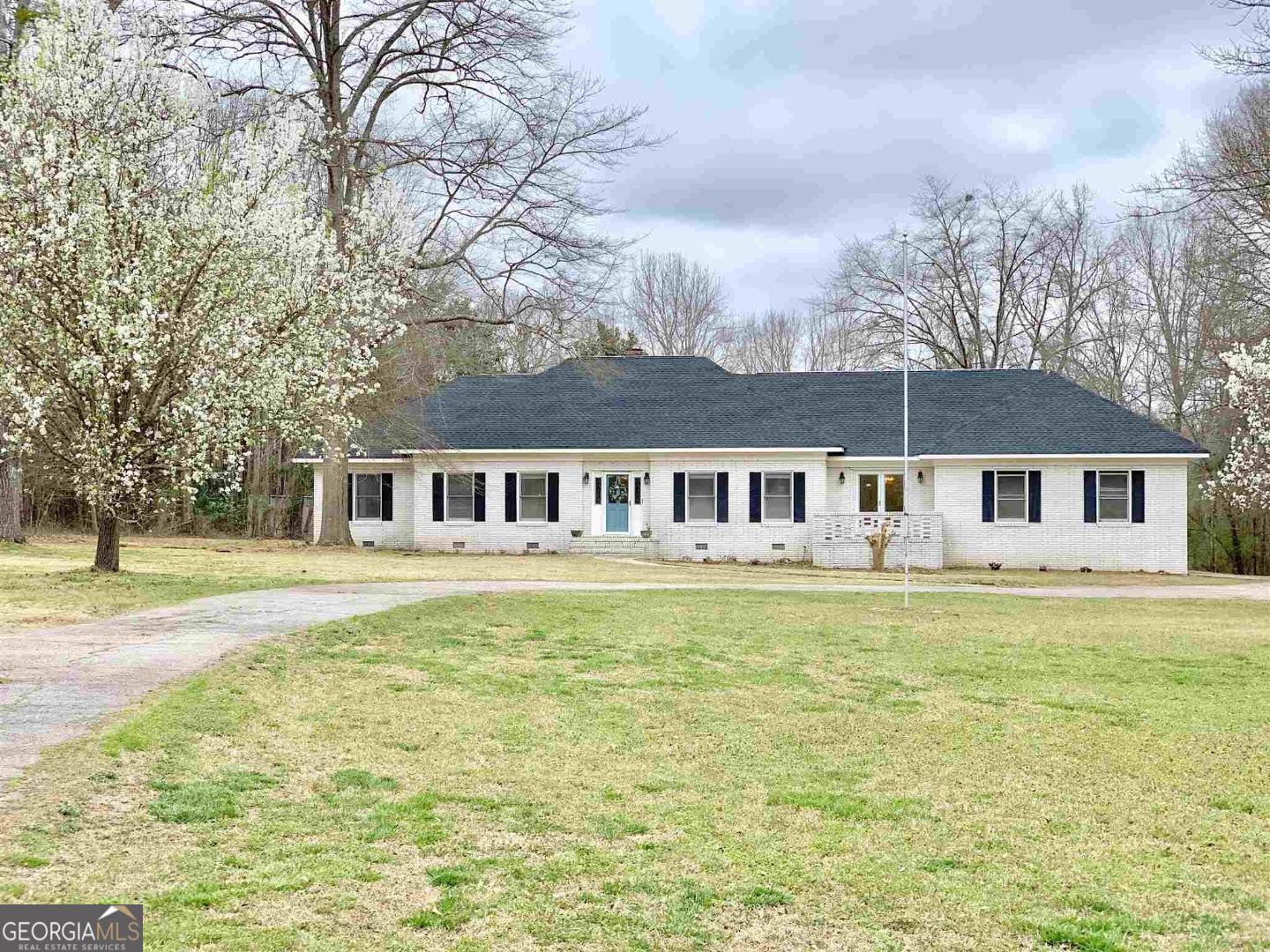 a front view of a house with swimming pool having outdoor seating