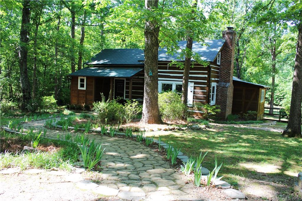 6915 Old Ridge Road Waxhaw, NC 28173 - Photo 1 of 21 a backyard of a house with plants and large tree