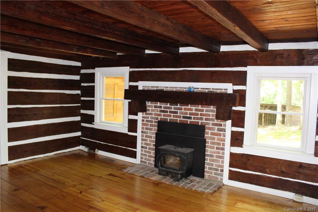 6915 Old Ridge Road Waxhaw, NC 28173 - Photo 10 of 21 a view of an empty room with a fireplace and a window