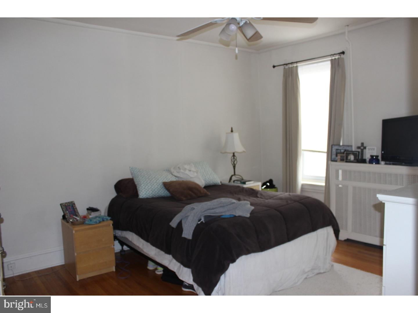 414 Leverington Avenue, Unit 2 Philadelphia, PA 19128 - Photo 13 of 17 a bedroom with a bed and a television in it