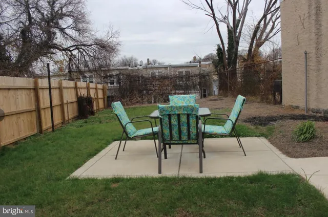a view of a table and chairs in the garden
