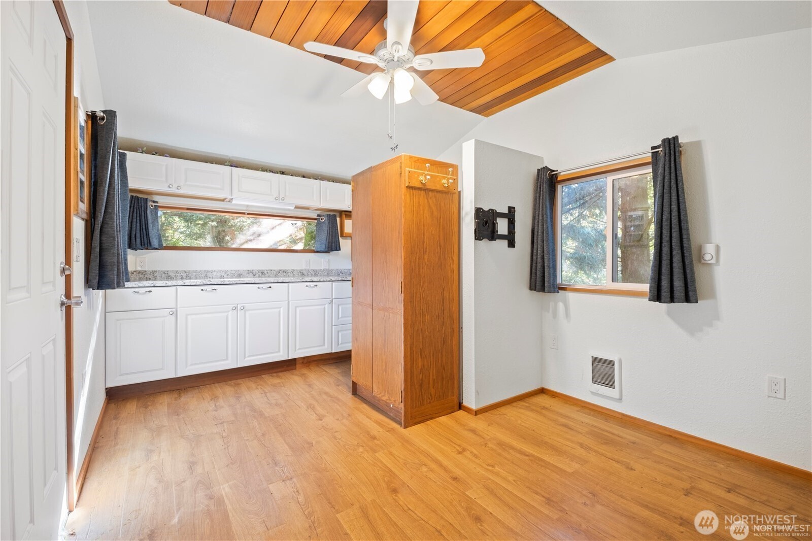 14310 200th Avenue Southeast Renton, WA 98058 - Photo 11 of 39 a view of a kitchen with wooden floor and a cabinet