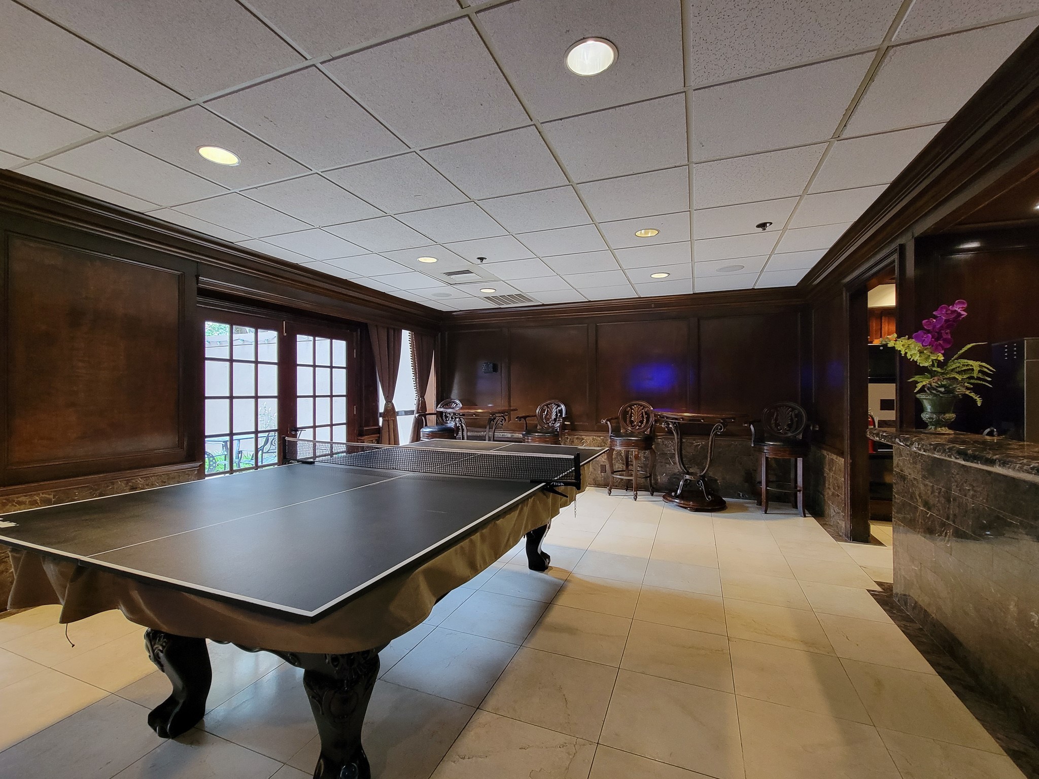 3525 Sage Road, Unit 1605 Houston, TX 77056 - Photo 22 of 33 Entertain in style with a versatile game room, featuring a convertible pool and ping pong table. Doors open to a lovely private patio! A full kitchen with appliances add to the ease of entertaining in this reservable space.