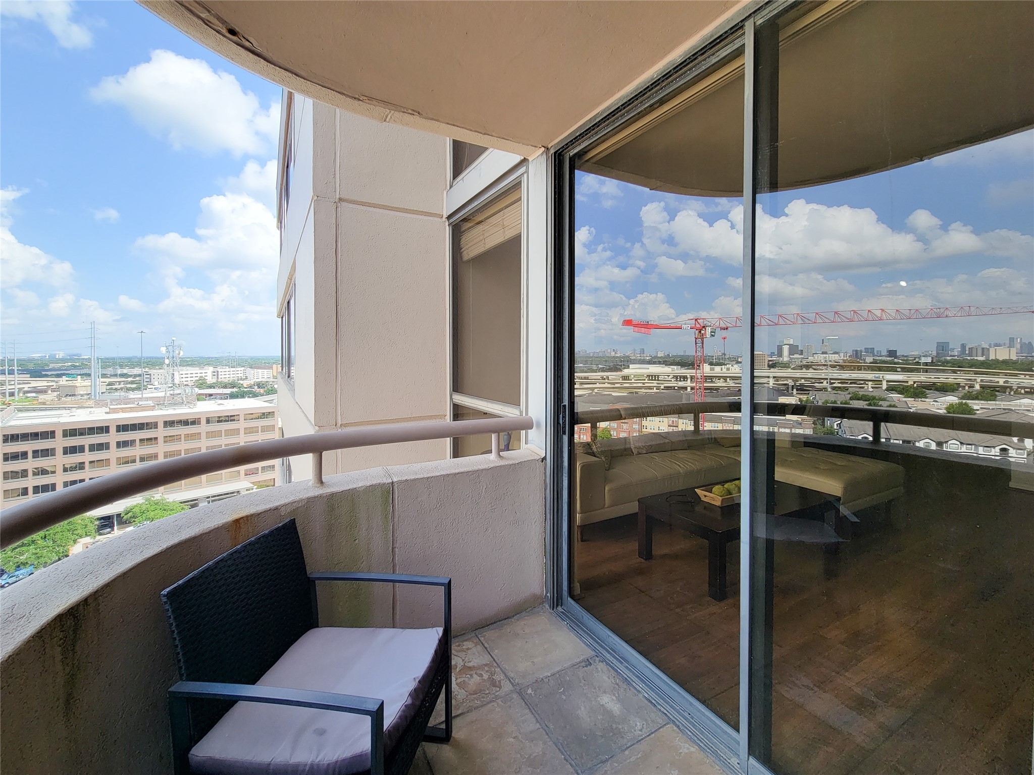 3525 Sage Road, Unit 1605 Houston, TX 77056 - Photo 3 of 33 High-rise apartment balcony offers city views, with space for seating. The sliding glass door from the living area reflects the view!