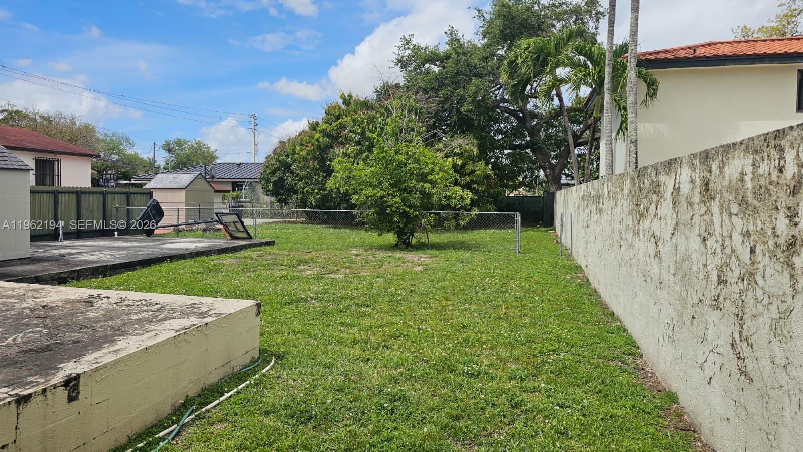 8891 Southwest 28th Street Miami, FL 33165 - Photo 23 of 25 a view of a backyard with large trees