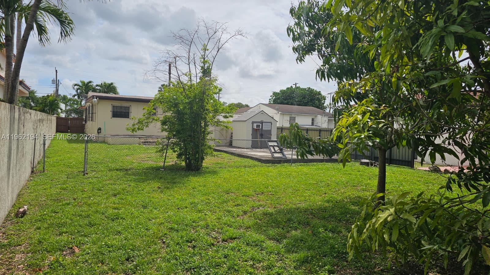 8891 Southwest 28th Street Miami, FL 33165 - Photo 24 of 25 a view of a house with a backyard