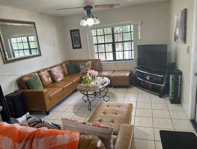 8891 Southwest 28th Street Miami, FL 33165 - Photo 7 of 25 a living room with furniture a flat screen tv and a window