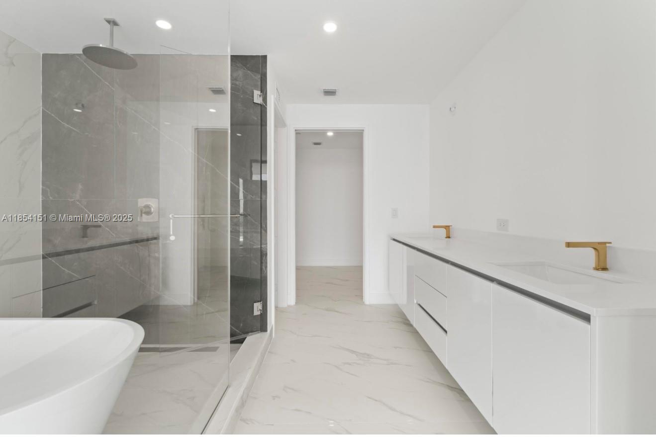 700 Northeast 24th Street, Unit 4907 Miami, FL 33137 - Photo 22 of 47 a bathroom with a granite countertop sink a toilet and shower